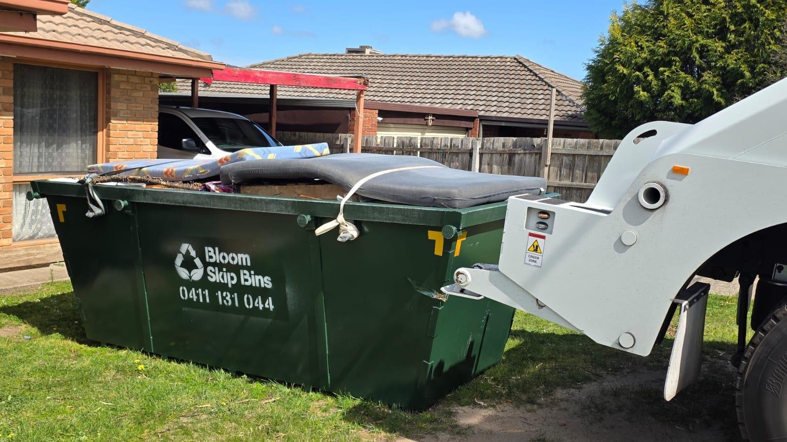 Full skip bin being collected by a Bloom Skip Bins truck