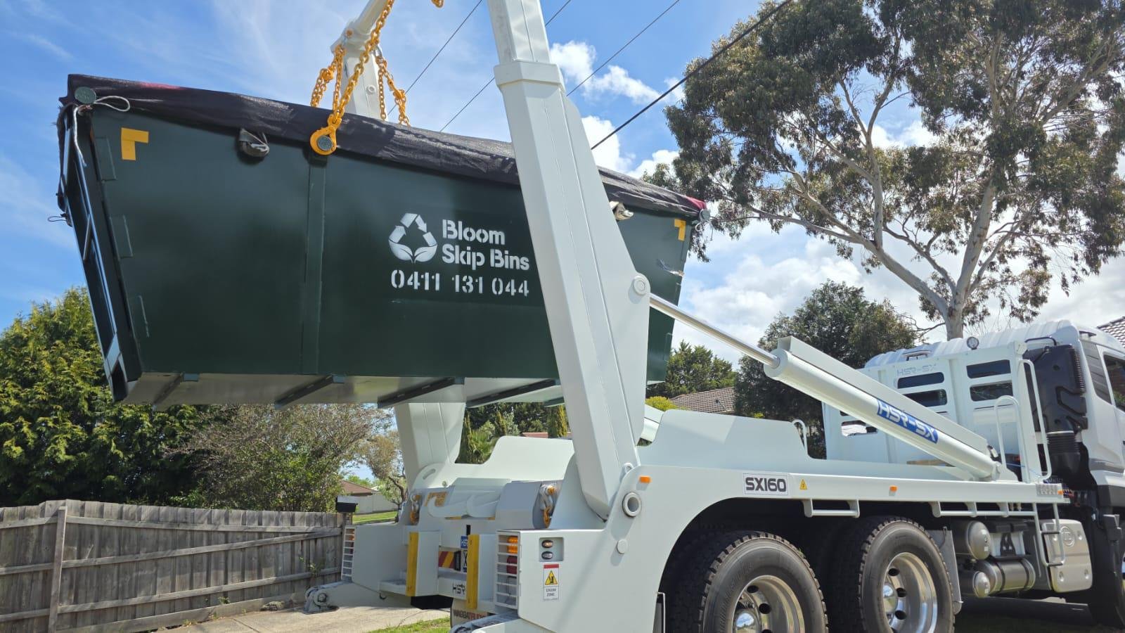 Bloom Skip Bins truck lifting a 10m³ construction bin from a Melbourne site